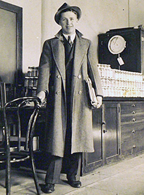 Norman at the University of Minnesota in a long coat and hat.